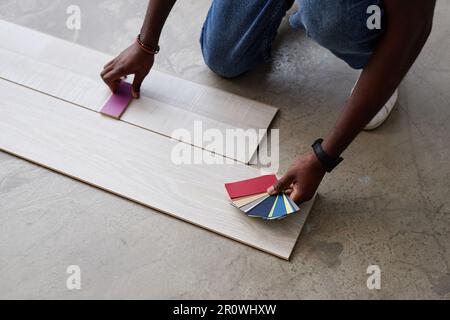 High angle view of designer choosing color for floor from pattern while working over new project Stock Photo