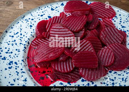 Slices of pickled red beets on a plate Stock Photo