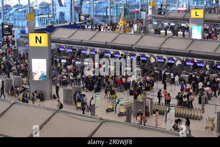 Overhead view of a the busy check in or departure hall, where airline passengers register for departing flights, of Suvarnabhumi Airport, Bangkok, Thailand, May 2023. Many passengers wait to check in to their flight. Stock Photo