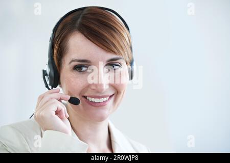 What can I do for you today. a beautiful young customer service agent working in an office. Stock Photo