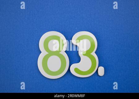 Number eighty-three blue color over a red background. Anniversary ...