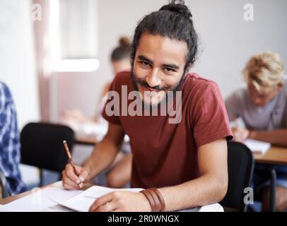Good grades Check. a young college students in class. Stock Photo