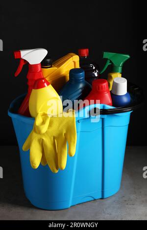 Light blue bucket with car cleaning products on grey table Stock Photo