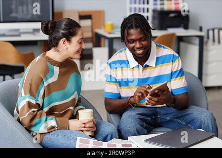 Colleagues discussing online presentation on digital tablet in team during meeting in office Stock Photo