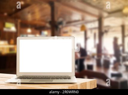 Laptop on a wooden table against the background blurred floating market with a clipping path touchscreen, space for your message. Stock Photo