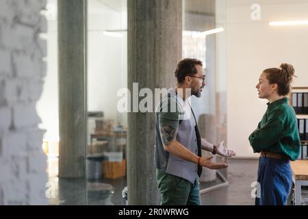 Colleagues arguing in office, problems at work. Stock Photo