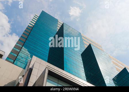 Perspective and underside angle view to textured background of modern glass building,Common modern business skyscrapers, high-rise buildings, Concepts Stock Photo