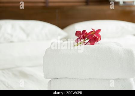 Close up, Fresh Towel with flowers placed on the inside of the hotel room. Stock Photo