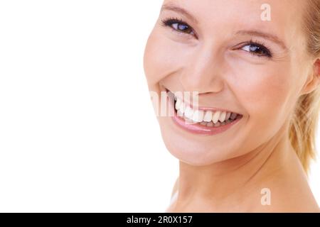 Sweet and radiant smile. Studio shot of a young woman smiling widely at the camera. Stock Photo