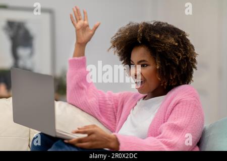Excited businesswoman celebrating success, using laptop at home Stock Photo