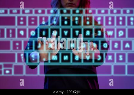 Businesswoman typing on virtual, digital wireless keyboard, working with statistics, programming. Futuristic technology transformation Stock Photo