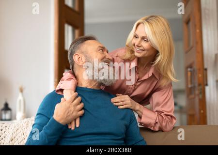 Happy European Spouses Embracing Expressing Happiness Posing At Home Stock Photo