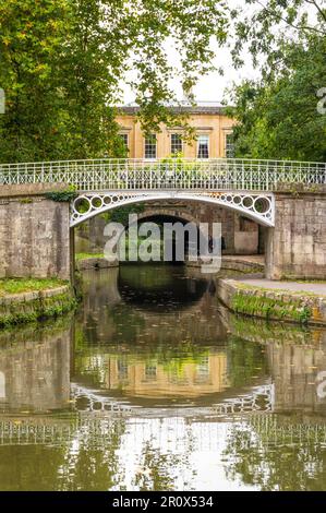 Sydney Gardens cast iron footbridge and Cleveland tunnel, with Cleveland House in the background, Kennet and Avon canal, Bath, Somerset, England Stock Photo