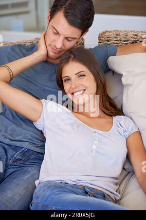 Day of leisure and love. an affectionate young couple relaxing at home. Stock Photo