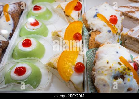 Italian pastry pastries. Traditional Sicilian sweets. Sicilian cassata. Traditional Sicilian pastries with sweet ricotta displayed in a shop. Stock Photo