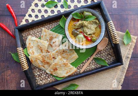 Green curry beef served with Roti at top view - Thai food called Roti Kang Keow Wan , is fusion of Thai authentic food combine with Indian Roti Stock Photo