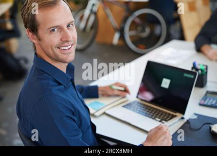 Developing tomorrows tech today. a designer at their workstation in an office. Stock Photo