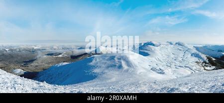 Morning winter mountain panorama with low-hanging clouds. View from the mount top  (Chornohora ridge, Carpathian, Ukraine). Stock Photo