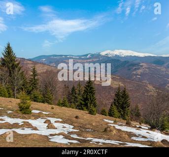 Early spring Carpathian mountains plateau landscape with snow-covered ridge tops in far, Ukraine. Stock Photo