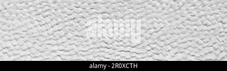 White rough plaster facade with rough bumpy surface Stock Photo