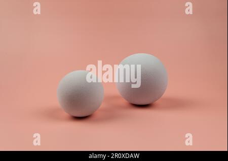 3D white balls on pink background. Two balls composition. Copy space. Stock Photo