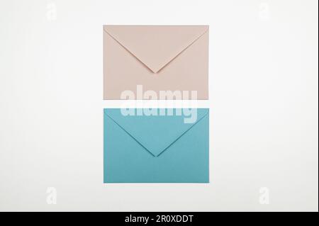 Top view of pink and blue envelopes on white background. Two envelopes, post flat lay. Copy space. Stock Photo