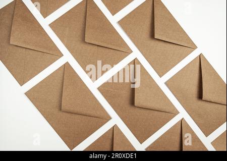 Top view of kraft paper envelopes on white background. Post flat lay, copy space. Stock Photo