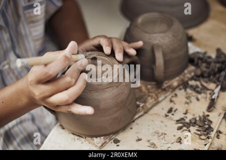 Pottery workshop, the process of making ceramic tableware, women’s hands Stock Photo