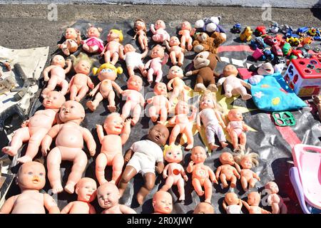 Toy dolls put up for sale on display at a free fair with various other toys Stock Photo