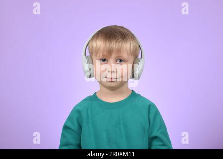 boy child listens to music in headphones Stock Photo