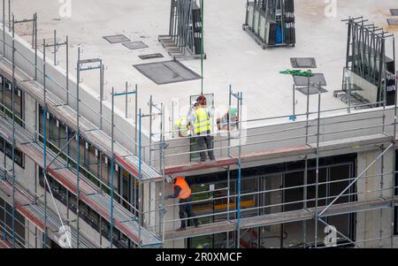 Glazier installing windows on a commercial building. Stock Photo