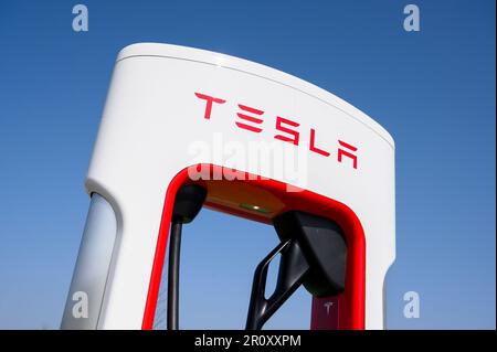 Tesla Supercharger at a motorway service station in England. Stock Photo