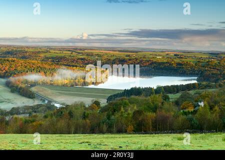 Swinsty Reservoir sunlight (long-distance, colourful hillsides, sunny cold misty weather, blue sky, water) - Washburn Valley, Yorkshire, England, UK. Stock Photo