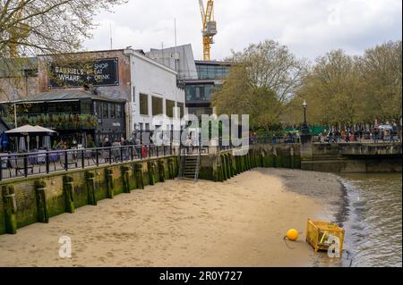 LONDON - April 21, 2023: Enjoy the urban buzz of Southbank's bars and restaurants, or unwind on the sandy riverside beach. Stock Photo
