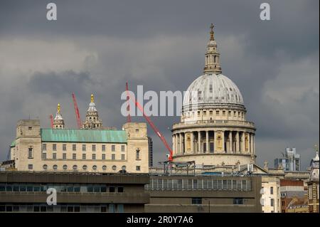 LONDON - April 21, 2023: The iconic St Paul's Cathedral stands tall amidst the bustling city of London, with construction cranes visible in the backgr Stock Photo