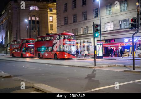 LONDON - April 21, 2023: Experience the iconic transportation system of London with two red double decker buses waiting at the County Hall bus stop on Stock Photo