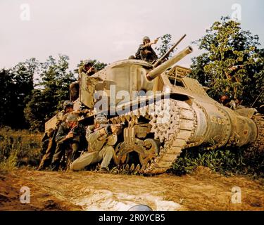 A propaganda photo showing a U.S. Army M-3 tank and crew using small arms at Ft. Knox, Ky.  June 1942. A photographer's flash reflector can be seen at the bottom of the image. Photograph By Alfred T. Palmer / Office Of War Information. Stock Photo