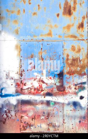 Old rusty metallic gate with spatters of paint, grunge background Stock Photo