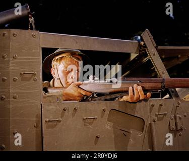 Halftrack infantryman with Garand rifle, Ft. Knox, Ky., June, 1942. In this staged propaganda photograph, a blue photographer's flashbulb was inadvertently left on the frame of the halftrack. Photograph By Alfred T. Palmer, FSA/OWI. Stock Photo