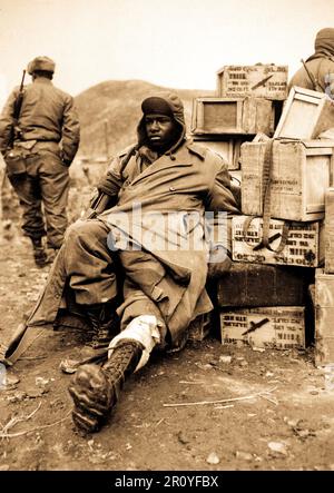 Pfc. Edward Wilson, 24th Inf. Regt., wounded in leg while engaged in action against the enemy forces near the front lines in Korea, waits to be evacuated to aid station behind the lines.  February 16, 1951. Photo by Pfc. Charles Fabiszak. (Army) Stock Photo