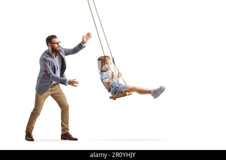 Father pushing a little girl on a swing isolated on white background Stock Photo