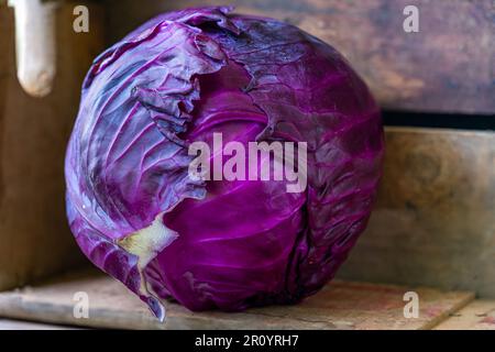Red cabbage in a wooden crate isolated. Stock Photo