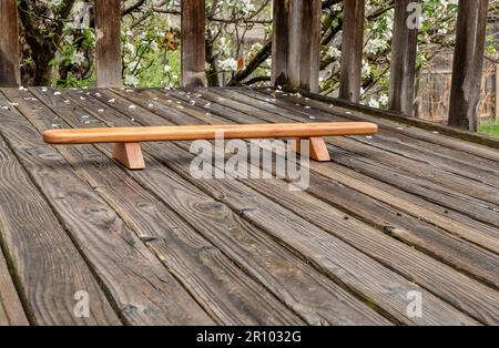 Persian shena push up board on a backyard wooden deck in springtime scenery Stock Photo