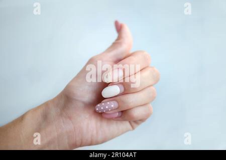 Weak thin nail. Consequences of gel polish manicure. Regrown nails after shellac. Stock Photo