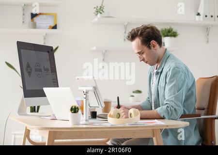 Male graphic designer developing logotype in office Stock Photo