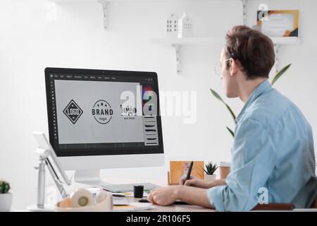 Male graphic designer developing logotype in office Stock Photo