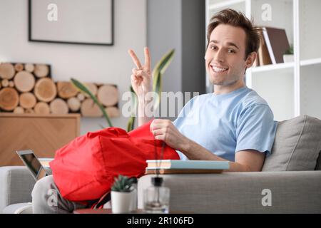 Male student with backpack at home Stock Photo