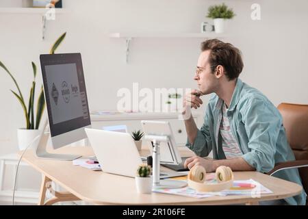 Male graphic designer developing logotype in office Stock Photo