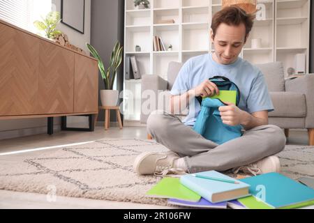 Male student with backpack at home Stock Photo