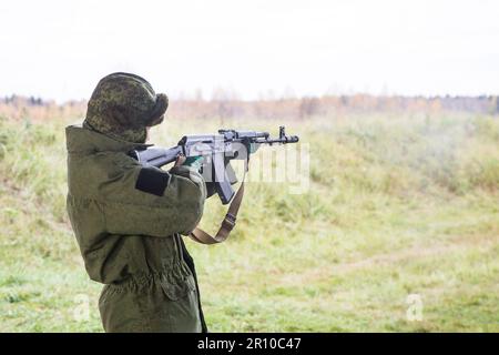 Man shooting at a target. Unformal shooting range  Stock Photo